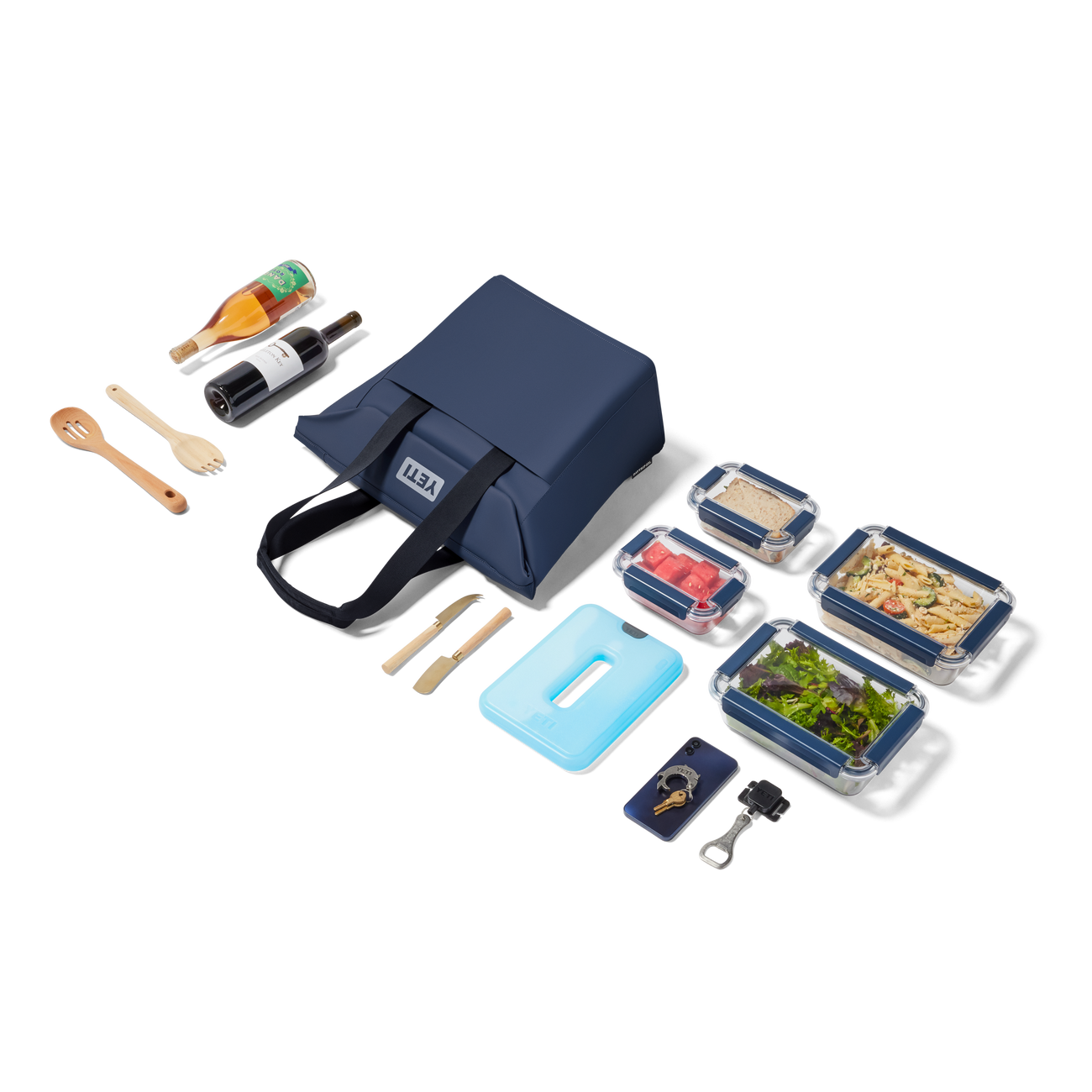 YETI picnic tote with food containers, utensils, and condiments on a white background